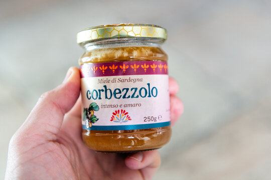 Cagliari, Italy - April 27, 2024: Corbezzolo strawberry tree honey from Sardinia island with bitter dessert food ingredient macro closeup