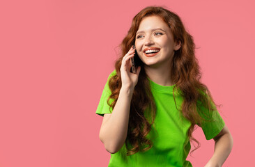 Fototapeta premium Attractive young woman Talking By Phone, Smiling. Young girl Lady On pink