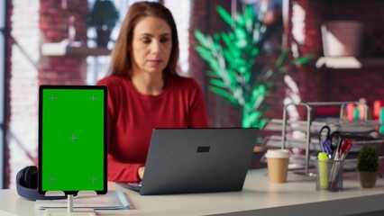 Confident woman solving tasks on a freelance platform next to mockup screen, answering emails and...