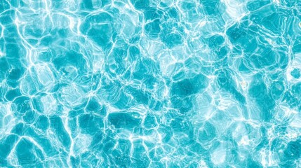 Turquoise pool water shimmers with sunlight, creating an abstract pattern of light and shadow on the surface. #pool #water