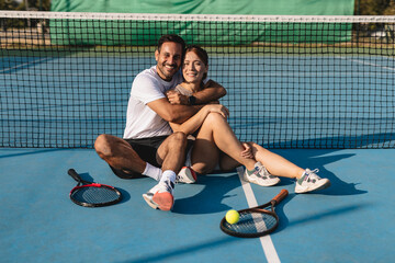 Two tennis players in action on the court with rackets, playing a competitive match