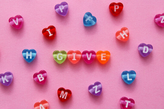 Give, colorful hearts with letters - Powered by Adobe