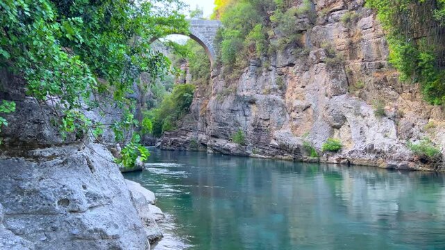 The historic Roman Oluk Bridge, or Eurymedon Bridge, in Koprulu Canyon. The ancient Roman bridge was built across the turquoise Kopruchai River in emerald green color.The National Park.Antalya,Turkey	