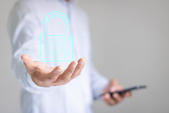 Data protection privacy concept. Business man hand holding a lock padlock icon. Cyber security computer network. Internet technology networking system. Protecting personal data information on tablet.