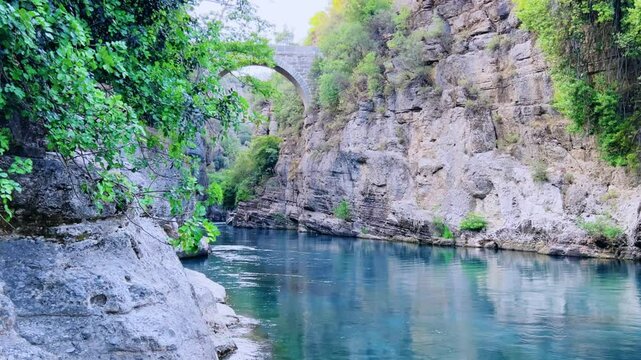 The historic Roman Oluk Bridge, or Eurymedon Bridge, in Koprulu Canyon. The ancient Roman bridge was built across the turquoise Kopruchai River in emerald green color.The National Park.Antalya,Turkey