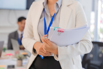 Businesswoman Holding Documents in Office