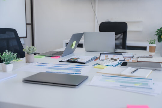 Cluttered Office Desk with Laptop and Documents - Powered by Adobe