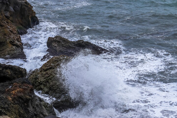 Ocean waves crashing against rocks in Iceland