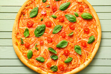 Tasty pizza margarita on green wooden background