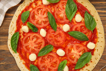Tasty pizza on wooden background