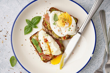 Plate of tasty sandwiches with egg on grey background