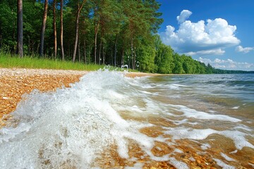 Wave rolls onto pebble beach. Trees line shore under a partly cloudy sky. Serene landscape