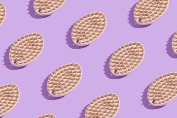 Pattern of soft brush for combing hair from pets on a pastel purple background