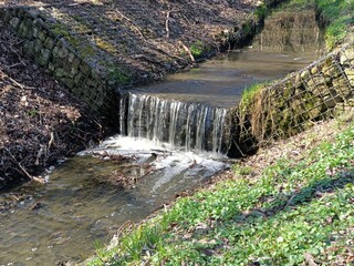 long decorative waterfall. flowing narrow river