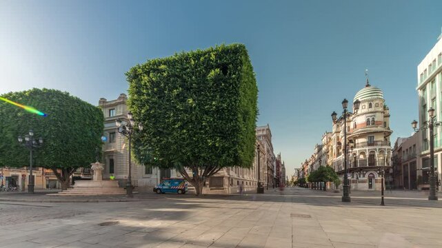 Panorama showing Avda. de la Constitucion, major avenue in Casco Antiguo district of Seville, Spain. Timelapse hyperlapse with Edificio de la Adriatica, historical buildings and passing trams