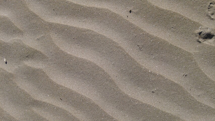 Beach Sand Background with Waves Texture Signs..wind patterns on sand.