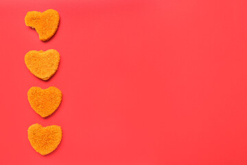 Tasty nuggets in shape of heart on red background. Valentine's Day celebration
