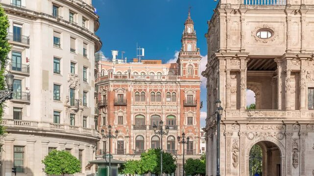 Morning timelapse of Central de Telefonica and the Town Hall in Plaza de San Francisco, Seville. Casa Consistorial, a masterpiece of Plateresque architecture with tram under a blue cloudy sky