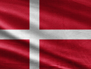Fototapeta premium Denmark flag waving in the wind with realistic fabric texture, white Nordic cross on red background.