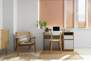 Interior of light office with workplace and armchair