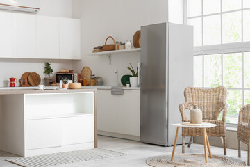 Interior of modern kitchen with refrigerator