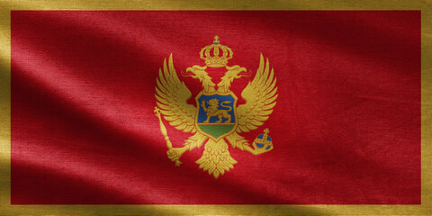 Montenegro flag waving in the wind with realistic fabric texture, red background, golden border and coat of arms with double-headed eagle.