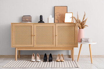 Interior of hallway with commode, table and shoes
