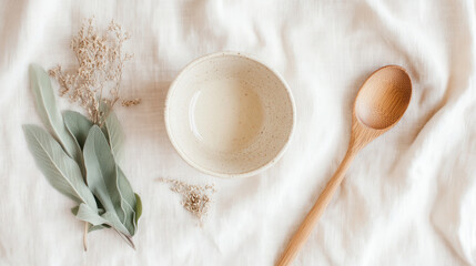 Minimalist flat lay with natural textures featuring ceramic bowl and wooden spoon for elegant kitchen decor