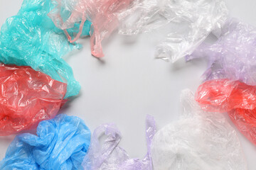 Frame made of crumpled plastic bags on grey background