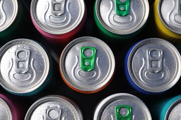 Many aluminium cans of beverage as background, top view