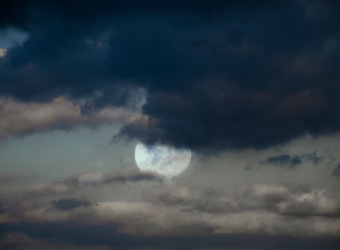 Dramatic cloudy sky at night with full moon - Powered by Adobe