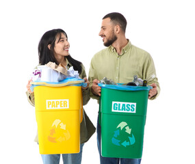 Young couple with sorted rubbish in garbage bins on white background. Global Recycling Day