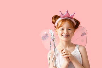 Cute girl in fairy costume with magic wand on pink background