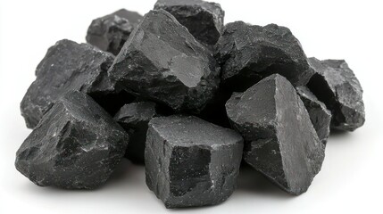 Pile of rough, dark, angular stones against a bright, white background
