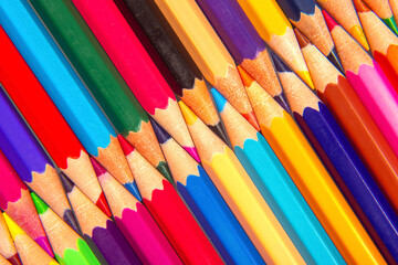 Sharpened colored pencils in a colorful layered design on a white backdrop. Ideal for artistic projects, school supplies, or creative stationery concepts.