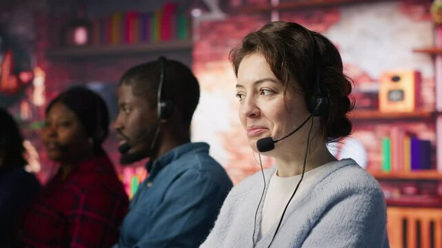 Friendly customer support workers respond to customers inquiries about products or services. Cheerful call center agent in office providing accurate and satisfactory information to customers, camera A