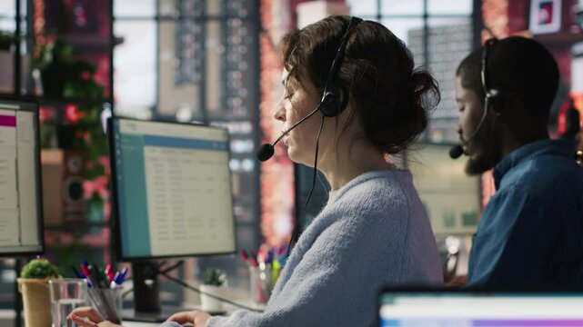 Account manager in office talking in headset mic, maintaining strong client relationships through regular communication. Employee talking with customer, Identify new sales opportunities, camera A