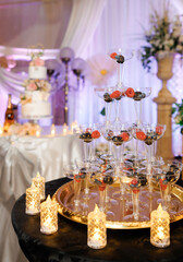 Close up of a berry bar with raspberries and blackberries in tower glasses at a wedding. Table with treats for guests. A table with berries is a healthy and simple snack for a wedding celebration