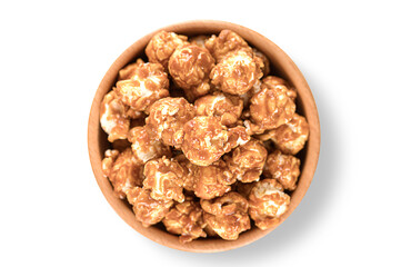 Caramel pop corn wooden bowl isolated on white background. Top view