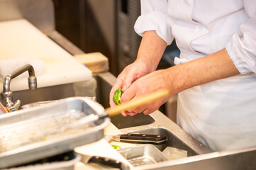 天ぷらを揚げる料理人