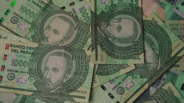 Close-up panoramic view of one-hundred-thousand guaran&iacute; bills from Paraguay