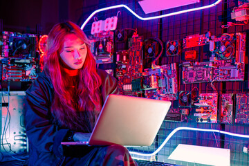 Software engineer typing coding in laptop computer at data center, Hacker woman is sitting at a desk with a laptop service in server room, Thinking and solve problems, Cyber security