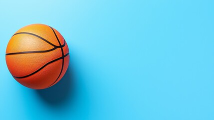 Obraz premium Bright orange basketball on a vibrant blue background with copyspace