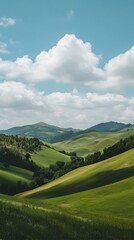 Serene rolling green hills under a bright blue sky with fluffy white clouds.  Perfect for desktop wallpaper, travel brochures, or nature-themed projects.