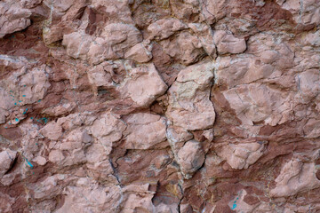 Natural Rock Formation Displaying Textured Layers and Earthy Colors in a Geological Landscape During Daylight