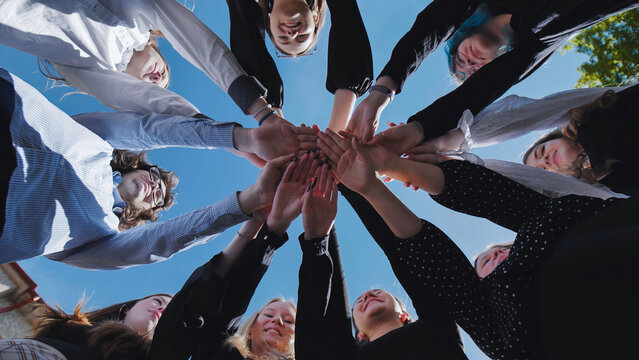 Students demonstrate unity and collaboration by forming a strong circle of joined hands during their school day
