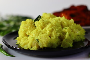 Boiled and mashed tapioca mixed with turmeric, chilies and curry leaves, served alongside fried fish