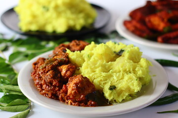 Boiled and mashed tapioca served with spicy chicken curry and crispy fried fish