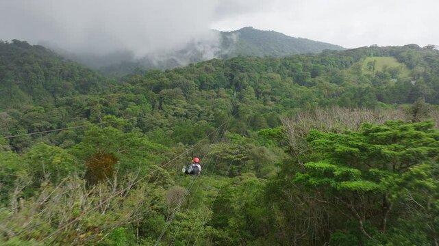 Experience the exhilarating thrill of ziplining high above the stunning and lush rainforest of Costa Rica, where breathtaking views and excitement await every intrepid adventurer