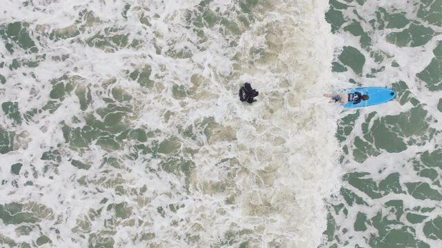Costa Rica - JUNE 6, 2024: In beautiful Costa Rica, a dedicated surf instructor teaches a young boy surfing on picturesque beaches, capturing joy and excitement of riding the waves in this tropical